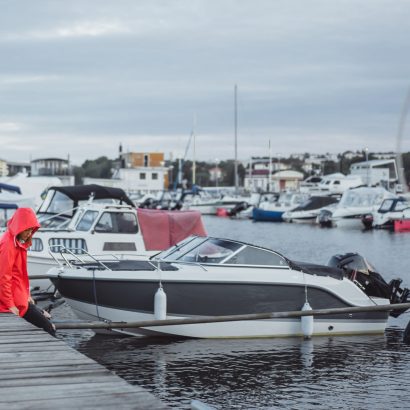 Beautiful young woman in a red cloak in the yacht port. Stockhol Beautiful young woman in a red cloak in the yacht port. Stockholm, Sweden